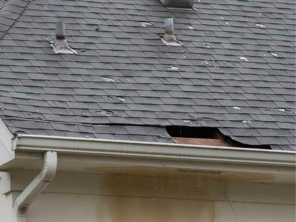 roof with missing shingles and interior ceiling water damage from hail storm